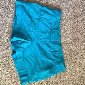 Teal medium length woman’s shorts.
